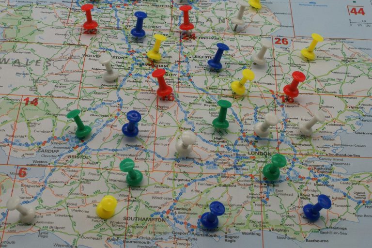A map marked with various coloured push pins indicating locations. A map marked with various coloured push pins indicating locations.